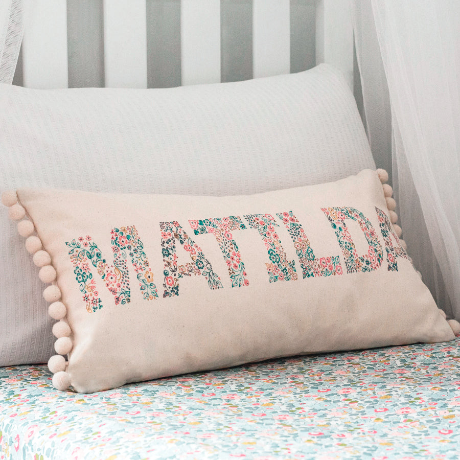 cotton cushion with pompoms and personalised name